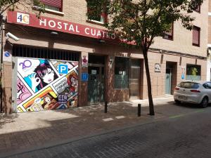 un edificio con un murale sul lato di Hostal 4C Cuatro Caminos a Madrid