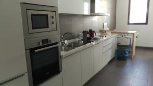 a kitchen with a sink and a microwave at Anfa Place in Casablanca