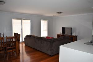 a living room with a couch and a table at Griffith Prestige Apartments in Griffith