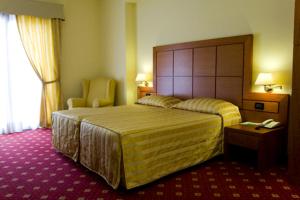 Postel nebo postele na pokoji v ubytování Hotel Grillo