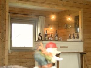 a toy figure in a kitchen with a window at Holiday Home A Pas de Loup in La Roche-en-Ardenne