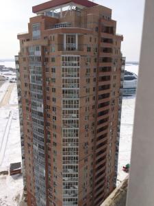 a tall building under construction in the snow at Apartment Erofey Arena at Morozova 87 in Khabarovsk