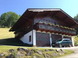 a house with a car parked in front of it at Apartment Lehengut in Eben im Pongau