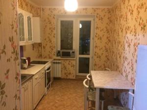 a kitchen with a sink and a stove top oven at Apartment Erofey Arena at Morozova 87 in Khabarovsk