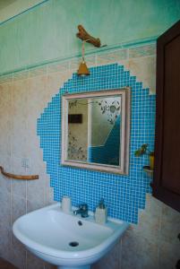 a bathroom with a sink and a mirror at B&B Terra e Paglia in SantʼAnna