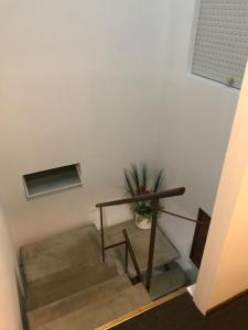 a staircase with a table and a potted plant at Hotel Antares in Montevideo