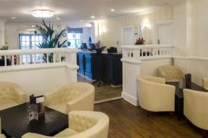 a salon with chairs and a table and a counter at Kings Hotel in Brighton & Hove