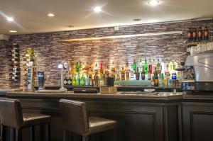 a bar with several bottles of alcohol on a brick wall at Kings Hotel in Brighton & Hove