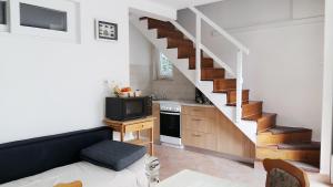 a living room with a staircase and a kitchen at Studio Apartman Kaćunić in Split