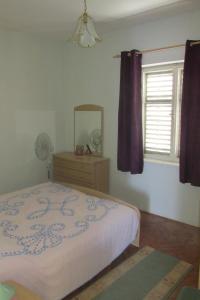 sypialnia z łóżkiem, lustrem i oknem w obiekcie Holiday home w mieście Sušica