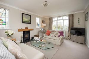 a living room with a couch and a fire place at Callender House in Harrogate