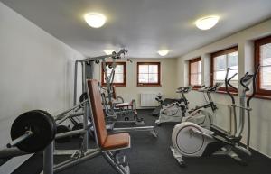 a gym with several tread machines in a room at Hotel Stoh in Špindlerův Mlýn