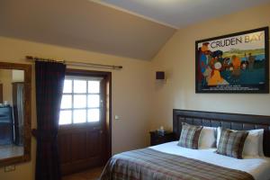 Postel nebo postele na pokoji v ubytování Kilmarnock Arms Hotel
