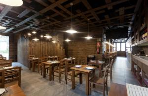 Un comedor con mesas y sillas de madera. en Pension Restaurante Casa Camiño, en Palas de Rei  19 fotos más