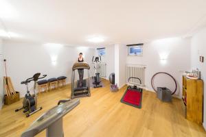 a woman is in a gym with exercise equipment at Kurhotel Roswitha in Bad Wörishofen
