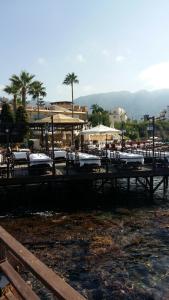 a group of tables with chairs and umbrellas at Tempo Sea Suits in Kérynia