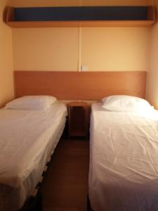 two beds in a small room with at La Canardiere in Casta