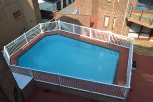 a large swimming pool with a balcony on top of a building at See Uitsig 12 in Uvongo Beach