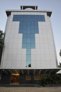 a tall building with a lot of windows at Hotel Abigail Regency in Shirdi