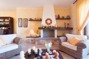 a living room with two couches and a fireplace at Villa Rose in Marina di Mancaversa