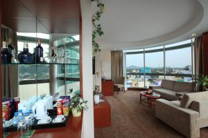 a living room with a couch and a living room with at River Hotel in Hà Tiên