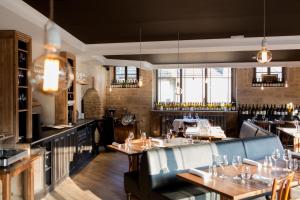 a restaurant with tables and chairs and a bar at La Rotisserie du Chambertin in Gevrey-Chambertin