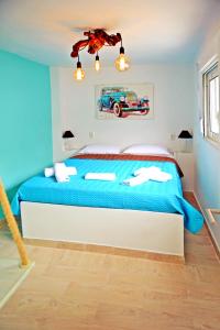 a bedroom with a blue bed with a car on the wall at Praxitelous 9 Old Town in Rhodes Town