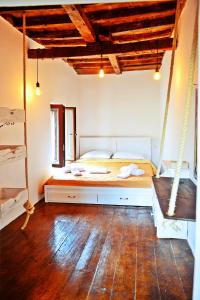 a bedroom with a swinging bed in a room at Praxitelous 9 Old Town in Rhodes Town