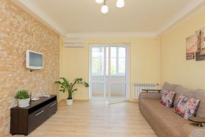 a living room with a couch and a tv at Apartment on Obolonskiy Prospect 16V in Kyiv