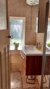 a bathroom with a sink and a window at Spacious King Bedroom in Grantham Lincolnshire in Grantham