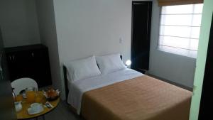 Postel nebo postele na pokoji v ubytování A Bogota On Holidays by Open - HOTEL CAS-EMBAJADA AMERICANA