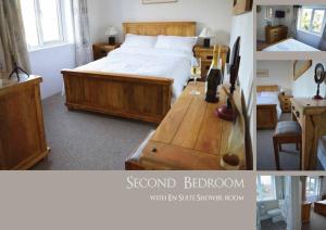 Un dormitorio con una cama y una mesa con botellas de vino. en Trekkle Cottage, en Gatehouse of Fleet