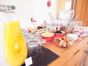 a counter with a line of glasses and bowls of food at The Old Dairy Farm in Emsworth