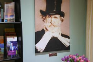 
a painting of a man with a hat on his head at Hotel Verdi in Rostock
