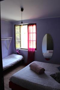 a bedroom with a bed and a mirror and a window at Room & Bike shuttle tour in Finale Ligure