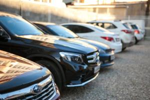 a row of parked cars parked next to each other at Hotel Kiparis in Adler