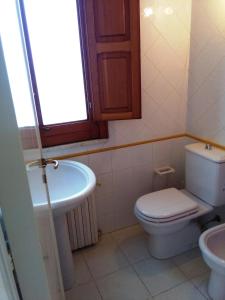 a bathroom with a toilet and a sink at The House on the Beach in Giardini Naxos