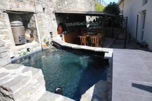 a swimming pool in the middle of a house at Hotel Garni Morettina in Brissago