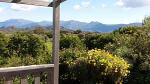 a wooden porch with a view of the mountains at La Canardiere in Casta