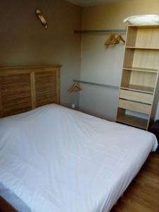 a bedroom with a white bed and a ladder at Chic'o Rail in Saint-Omer