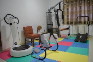 a room with a gym with exercise equipment on the floor at Hotel Galicia in Poio