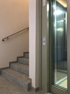 a set of stairs in a building with a glass door at Residence Kalliste in Ajaccio