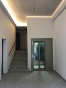 an empty hallway with stairs and a glass door at Residence Kalliste in Ajaccio