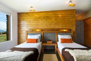 Ένα ή περισσότερα κρεβάτια σε δωμάτιο στο Hotel Altiplanico Puerto Natales