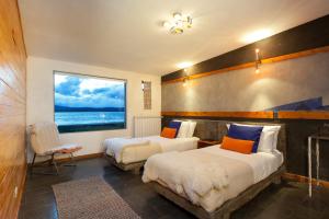 Ένα ή περισσότερα κρεβάτια σε δωμάτιο στο Hotel Altiplanico Puerto Natales