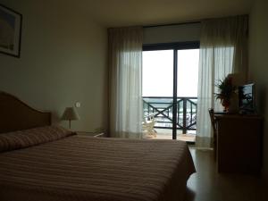Postel nebo postele na pokoji v ubytování Hotel Marina Uno
