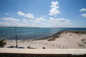 a view of a beach with the ocean at Hotel Alba in Torre Lapillo