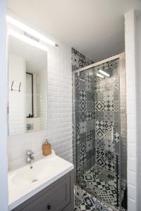 a bathroom with a sink and a glass shower at Studio Couleur Soleil in Roquebrune-Cap-Martin +18 photos