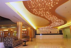 a lobby with a bunch of lights on the ceiling at Lemnos Village Resort Hotel in Platy +76 photos