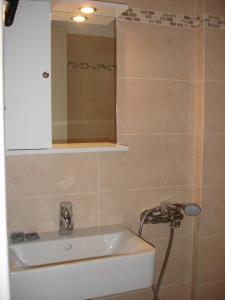 a bathroom with a sink and a mirror at Panorama in Perama